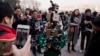 FILE - A journalist operate a harness with multiple recording devices capable of recording and live streaming outside the Great Hall of the People in Beijing, China. 