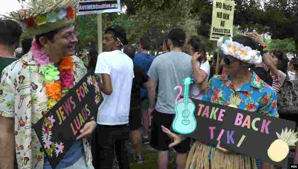 Counter-protester Jesse Belsky (left) came dressed for a luau to mock the white supremacists who carried tiki torches at the Unite the Right rally in Charlottesville, Virginia, last year.
