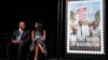 Actress Gabrielle Union and Congressman John Lewis sit on stage at the Newseum in Washington, D.C., at the unveiling of a U.S. Postal Service stamp commemorating the 50th anniversary of the March on Washington, Aug. 23, 2013.