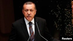 FILE - Tayyip Erdogan addresses members of his ruling AK Party during a meeting at the party headquarters in Ankara, Turkey, Aug. 14, 2014.