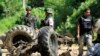Thai security personnel inspect the wreckage of a military truck after a bomb attack by suspected Muslim militants on a roadside in Yala province, south of Bangkok June 29, 2013. Suspected Muslim rebels in southern Thailand killed eight soldiers in the ro