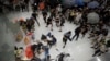FILE - Policemen scuffle with protesters inside a shopping mall in Sha Tin District in Hong Kong, July 14, 2019. 