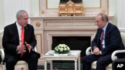 Israeli Prime Minister Benjamin Netanyahu, left, gestures while speaking to Russian President Vladimir Putin during their talks in the Kremlin in Moscow, Russia, Jan. 30, 2020. 