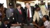 Independent Electoral and Boundaries Commission’s, IEBC, U.S. Ambassador to Kenya, Robert F. Godec, second right and British High Commissioner to Kenya, Christian Turner, second left, inside the voter registration centre in Thika Nairobi Kenya, Dec. 15, 2