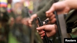 FILE - Fighters of the Revolutionary Armed Forces of Colombia (FARC) are seen in the Villa Colombia camp near San Vicente del Caguan, Caqueta province, Colombia, April 29, 2000.
