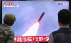 FILE - People watch a TV showing a file image of an unspecified North Korean missile launch during a news program at the Seoul Railway Station in Seoul, South Korea, Oct. 31, 2019.