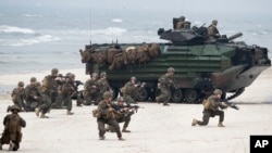 FILE - U.S. Marines with Amphibious Assault Vehicles take a part in a landing operation during Exercise Baltops 2018 along the Baltic Sea near the Lithuania village of Nemirseta, June 4, 2018. 