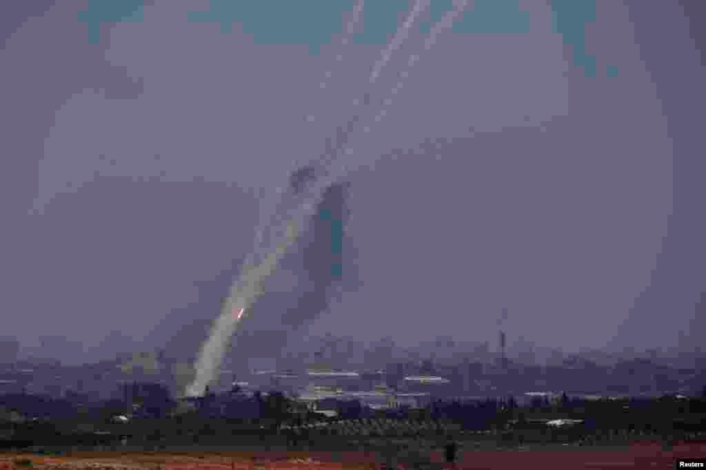 Smoke trails are seen as rockets are launched towards Israel from the northern Gaza Strip, July 10, 2014.