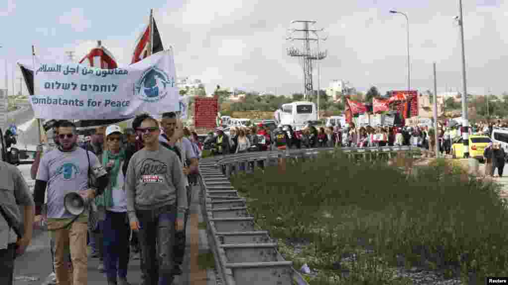 Palestinian and Israeli activists take part in a demonstration calling for a better future for both people and ahead of the annual International Women's Day, in the West Bank city of Bethlehem, March 4, 2016.
