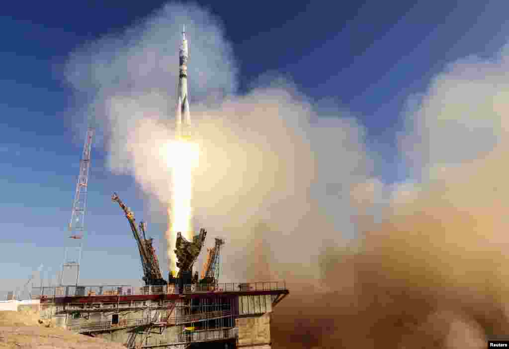 The Soyuz TMA-11M spacecraft decorated with the 2014 Sochi Winter Olympic Games logo and a blue-and-white snowflake pattern, blasts off from the launch pad at the Baikonur cosmodrome, Nov. 7, 2013.