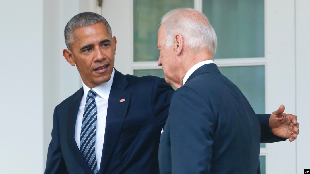 FILE - Then-President Barack Obama, accompanied by then-Vice President Joe Biden, walks back to the Oval Office after speaking in the Rose Garden of the White House, in Washington, Nov. 9, 2016.