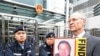 Solicitor John Clancey (R), a member of a lawyers concern group protests for the release of Beijing human rights lawyer Gao Zhisheng outside the China Liaison office in Hong Kong, 04 Feb 2010