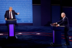 FILE - President Donald Trump and Democratic presidential nominee Joe Biden participate in their first 2020 presidential campaign debate in Cleveland, Ohio, Sept. 29, 2020.