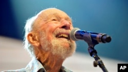 FILE - Pete Seeger performing on stage during the Farm Aid 2013 concert at Saratoga Performing Arts Center in Saratoga Springs, N.Y.