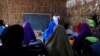 Zeinab's English teacher Abdiweli Mohammed Hersi teaches children at the school near a camp for internally displaced people from drought hit areas in Dollow, Somalia, April 3, 2017. 