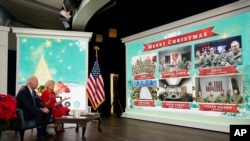 President Joe Biden, first lady Jill Biden and their new dog Commander, meet virtually with service members around the world, Dec. 25, 2021, in the South Court Auditorium on the White House campus in Washington, to thank them for their service and wish them a Merry Christmas.