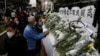 People queue up to pay tribute to former Chinese President Jiang Zemin, after he died aged 96, outside China's Liaison Office, in Hong Kong, Dec. 1, 2022.