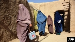 Afghan women from a polio immunization team carry out a vaccination campaign in Kandahar, Oct. 15, 2019. Polio immunization is compulsory in Afghanistan, but distrust of vaccines is rife, and the programs are difficult to enforce in rural areas.