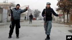 Afghan policemen stand guard near the scene where Afghanistan's Intelligence Chief Asadullah Khalid was wounded in an assassination attempt in Kabul, Afghanistan, December 6, 2012.
