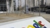 A man walks past the Google company logo outside the Google China headquarters in Beijing (file)