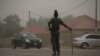 A policeman keeps watch on the road leading to Taraba state electoral commission during the announcement of the results of the Governorship and State assembly elections in Jalingo, Nigeria, April 12, 2015. 