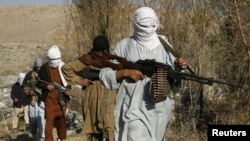 FILE - Armed Taliban fighters are seen at an undisclosed location in Nangarhar province, Afghanistan, Dec.13, 2010. A senior Afghan Taliban commander was killed Thursday by Afghan security forces in Nangarhar's Surkhrod district.