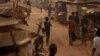 FILE - A boy walks in a camp sheltering internally displaced people next to the M'Poko international airport in Bangui, Central African Republic, Feb. 13, 2016.