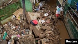 A man cleans up the clay after floods hit Jakarta, Indonesia, Jan. 3, 2020. (Antara Foto/Dhemas Reviyanto/via Reuters)