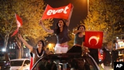 Supporters of the "Yes" vote, wave flags during celebrations in Istanbul, on Sunday, April 16, 2017.