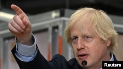 Britain's Prime Minister Boris Johnson gestures as he delivers a speech during his visit to Dudley College of Technology in Dudley, Britain, June 30, 2020. 