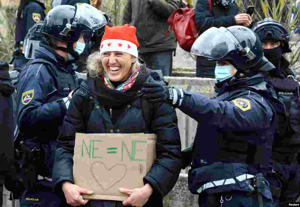 A woman reacts during a protest over COVID-19 restrictions, in Ljubljana, Slovenia.