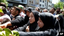Iranians attend the funeral of victims of Islamic State militant attacks, in Tehran, Iran, June 9, 2017. Twin attacks this week killed 17 people. 
