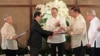 FILE - Philippine President Benigno Aquino, center, applauds as Moro Islamic Liberation Front chief negotiator Mohagher Iqbal, second from left, shakes hands with Senate President Franklin Drilon, second from right, at the presidential palace in Manila, September 10, 2014.