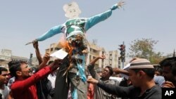 FILE - Indians burn an effigy of Pakistan and shout anti-Pakistan slogans during a protest in Ahmadabad, India, May 3, 2017.