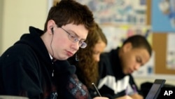 FILE -- Alex Jacobs works out math problems during a pilot math class at Reynoldsburg High School in Reynoldsburg, Ohio. In math, Asian-American students excel compared to other groups, according to a new study. 