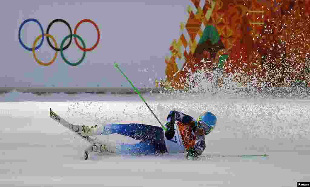 Winner Ted Ligety of the U.S. falls to the ground after the second run of the men's alpine skiing giant slalom event, Rosa Khutor Alpine Center, Feb. 19, 2014.