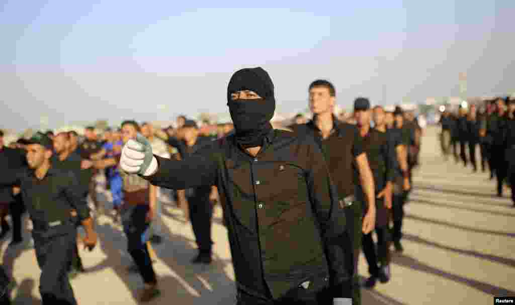 Mehdi Army fighters loyal to Shi'ite cleric Moqtada al-Sadr march during military-style training in the holy city of Najaf, Iraq, June 16, 2014.
