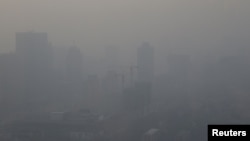 A construction site is pictured in smog on a polluted day as a red alert for air pollution is issued in Beijing, China, Dec. 16, 2016. 