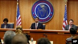 Federal Communications Commission (FCC) Chairman Ajit Pai, center, announces the vote was approved to repeal net neutrality, next to Commissioner Mignon Clyburn, left, who voted no, and Commissioner Michael O'Rielly, who voted yes, at the FCC, Dec. 14, 20