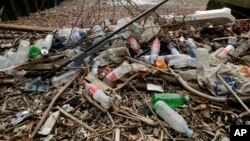Plastic bottles and other plastics lie washed up on the north bank of the River Thames in London, Feb. 5, 2018.