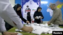Election officials count ballot papers after the close of polling stations during elections for the parliament and a leadership body called the Assembly of Experts, which has the power to appoint and dismiss the supreme leader, in Tehran, Feb. 26, 2016. 