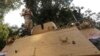 An Egyptian army soldier stands guard atop an armored personnel carrier as he talks on his mobile phone in Giza, south of Cairo, Aug. 19, 2013.
