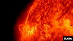 FILE - NASA's Solar Dynamics Observatory captured this image of the X1.2 class solar flare on May 14, 2013. Solar activity continued as the sun emitted a fourth X-class flare from its upper left limb. (Credit: NASA/SDO)