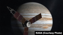 FILE - NASA’s solar-powered Juno is now taking 53 days to fly around Jupiter.
