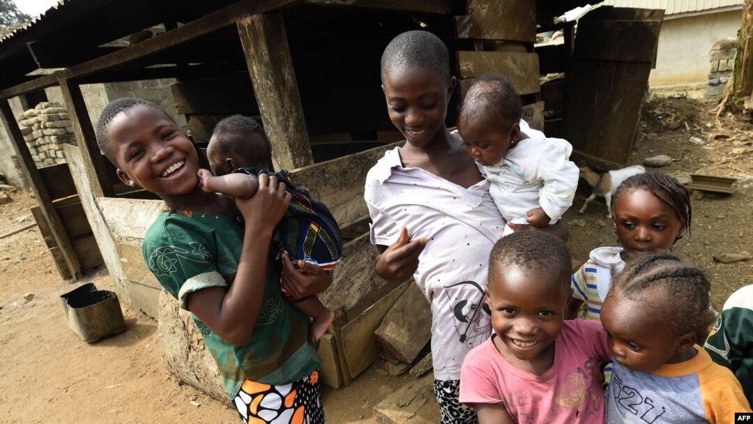 FILE - Young Cameroonian refugees carry children in Agborkim town, Etung district of Cross Rivers State, southeast Nigeria, Feb. 2, 2018. Millions of Cameroonian children reportedly do not have required birth certificates. 