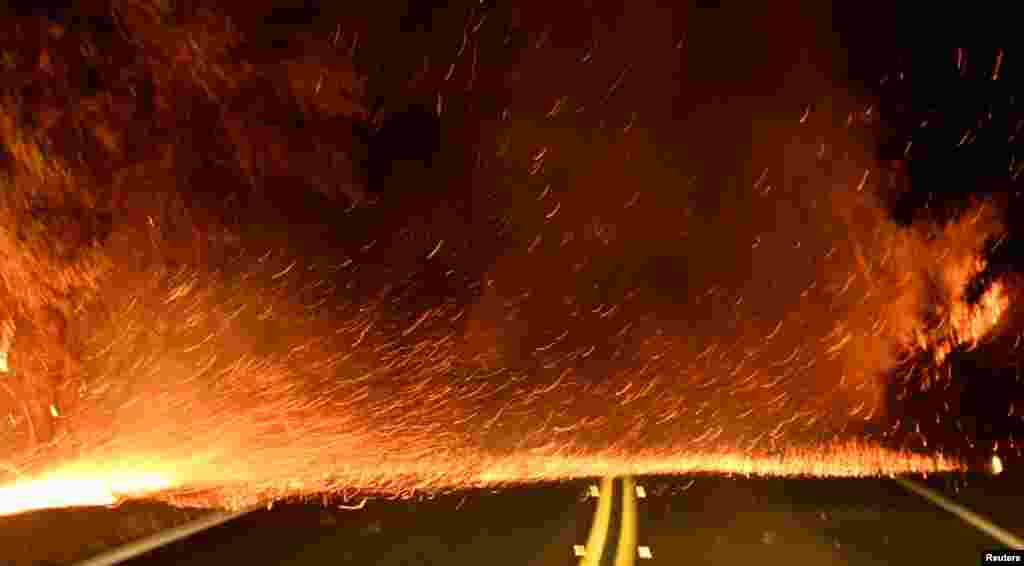 Embers spread across a roadway from a Santa Ana wind-driven brush fire called the Thomas Fire in Santa Paula, Dec. 4, 2017.