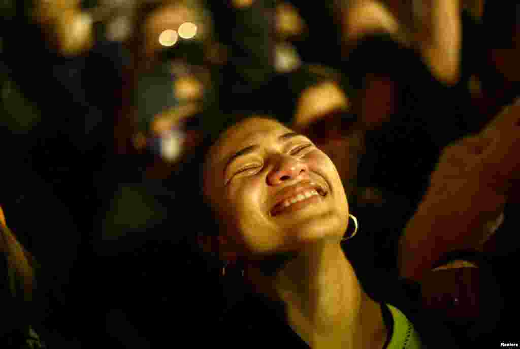 A woman reacts after news media declared Democratic candidate Joe Biden to be the winner of the 2020 U.S. presidential election, at BLM Plaza in Washington, DC, Nov. 7, 2020.