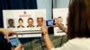 Reporters photograph wanted posters of people facing criminal charges before a news conference in Washington, June 15, 2017, about the May 16, 2017 altercation outside the Turkish Embassy in Washington during the visit of the Turkish president. 
