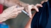 A man receives a COVID-19 vaccine at a clinic at Mother's Brewing Company in Springfield, Mo., on Tuesday, June 22, 2021.(Nathan Papes/The Springfield News-Leader via AP)