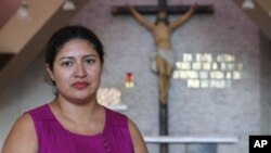 Cecilia Flores poses for a portrait inside the chapel where Archbishop Oscar Arnulfo Romero was assassinated in 1980, in San Salvador, El Salvador, Oct. 5, 2018. Flores underwent an emergency cesarean section and was diagnosed with an infection that left her in a coma. She was not expected to survive, but after her husband prayed to Romero for intervention, Flores made a full recovery. 